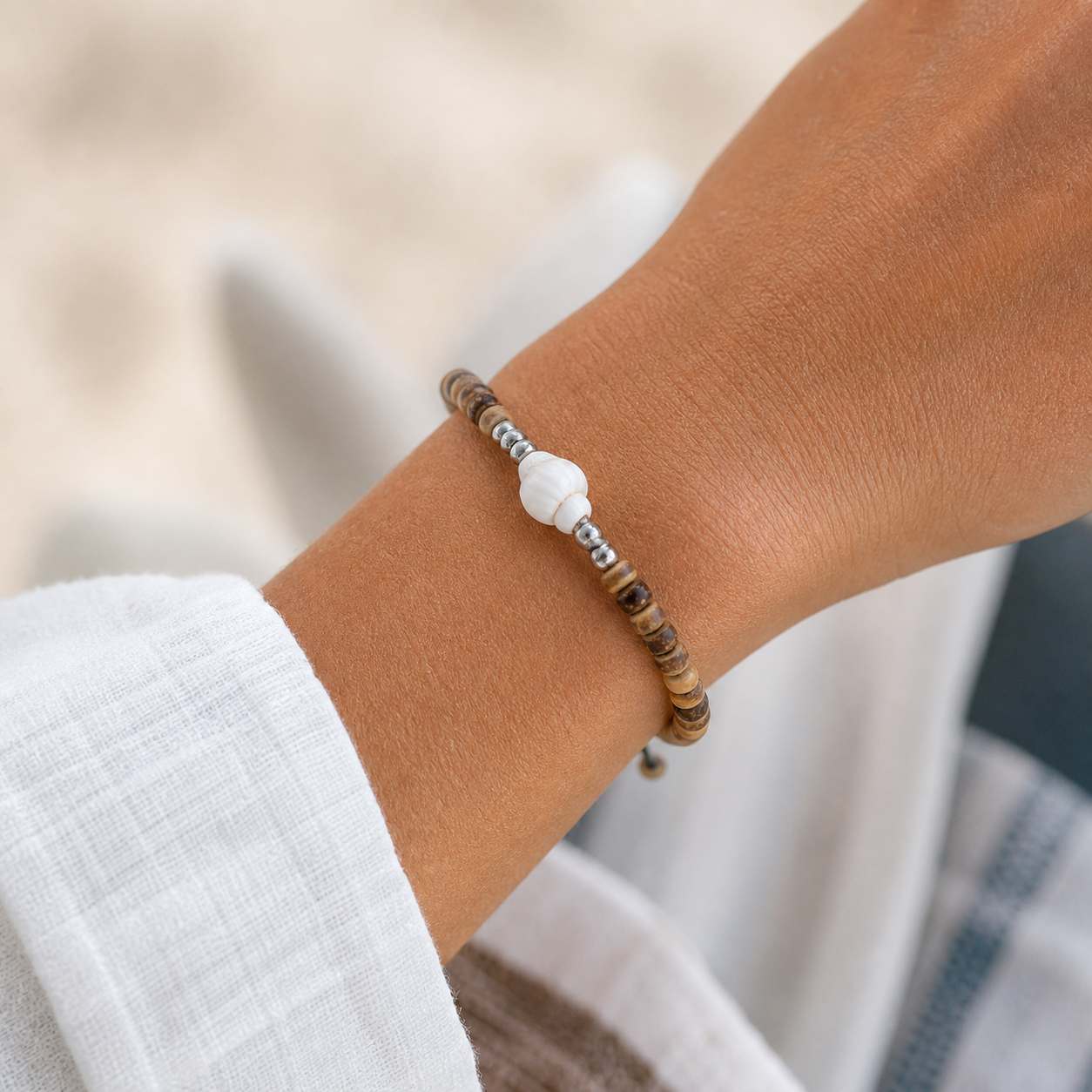 11 shell tide charm closeup wrist