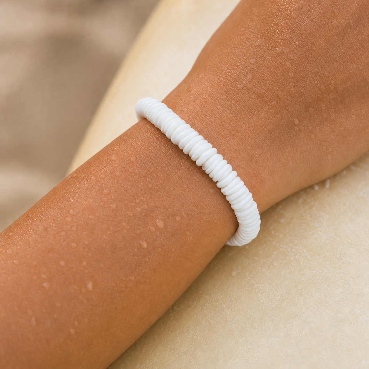 16 white puka shell closeup wrist