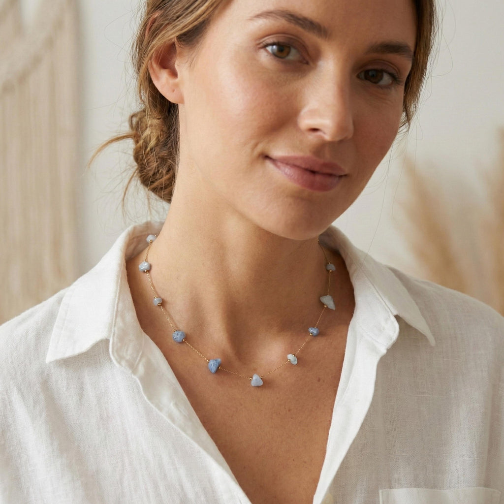 Blue moonstone pendant on a fine gold chain necklace worn at the neck