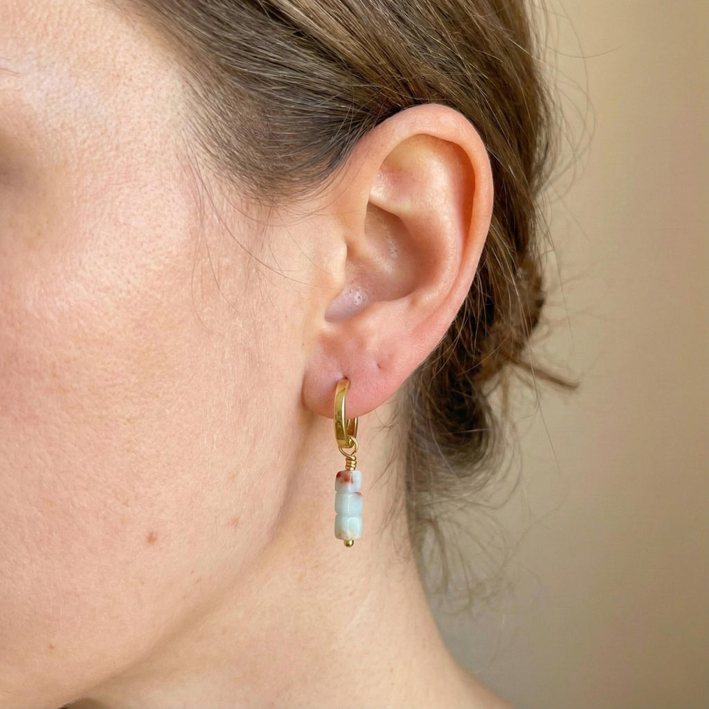 Gold vermeil hoop earring with an aqua stone drop worn on the ear