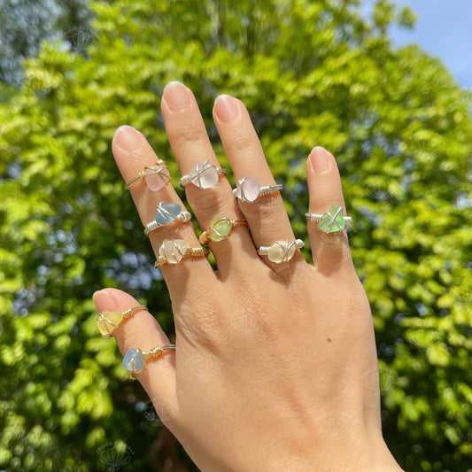Wire wrapped sea glass ring worn on a hand