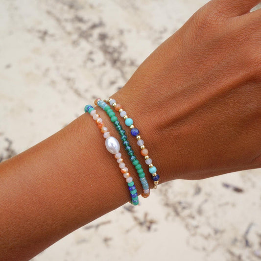 Set of beaded surfer bracelets with pearls on a wrist