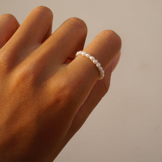 Dainty freshwater rice pearl ring worn on a hand