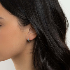 Gold huggie hoop earring set with blue opals worn on the ear